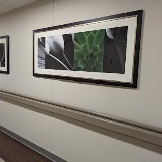 A corridor featuring framed artwork that adds a modern touch to the interior.
