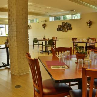 An empty restaurant interior with neatly arranged tables and chairs.