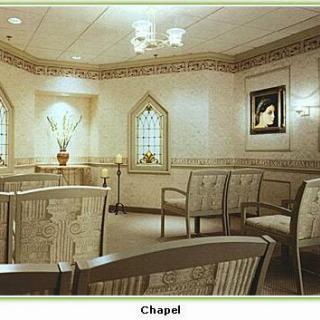 A serene chapel interior featuring elegant furniture and decorative elements.