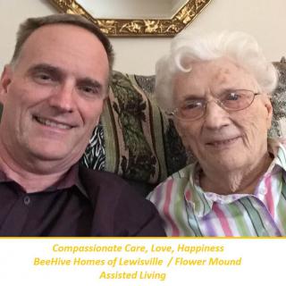 A selfie of two people, possibly a caregiver and an elderly person, taken indoors at an assisted living facility.