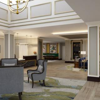 Elegant hotel lobby with a seating area and chandelier.