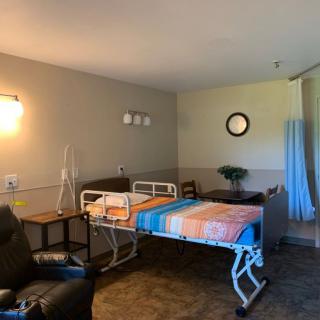 A hospital room with a bed and medical equipment.