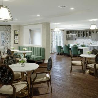 A modern and elegant dining area with neatly arranged tables and chairs.