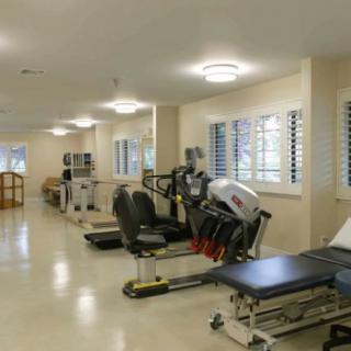 A well-equipped gym with various fitness machines and exercise areas.