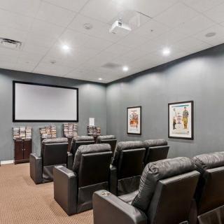 A cozy home theater room with reclining seats and a large screen, perfect for movie nights.