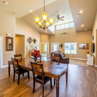 Spacious open-plan living and dining area with high ceilings and abundant natural light.