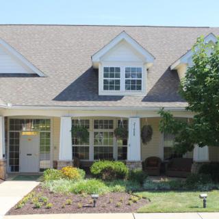A suburban house with a landscaped garden and a welcoming porch.