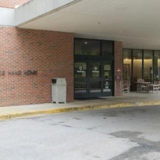 Entrance to a hall with brick walls and glass doors.
