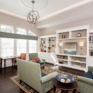 A cozy and modern living room with comfortable seating and elegant shelving.