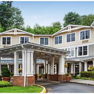 A elegant exterior view of a residential building with a covered entrance.