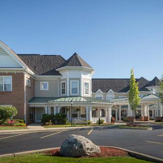 A well-maintained residential building with classic architecture and landscaped surroundings.