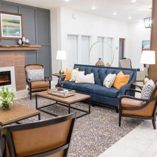 A modern living room featuring a blue sofa, elegant coffee table, and stylish decor.