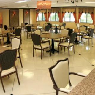 An empty dining room with tables and chairs arranged neatly.