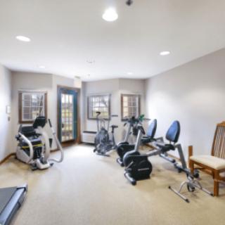 A well-equipped home gym with various exercise machines.