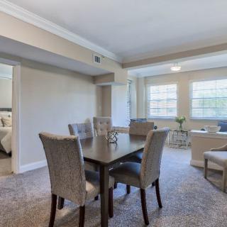 A cozy dining area connected to a living room with ample natural light.