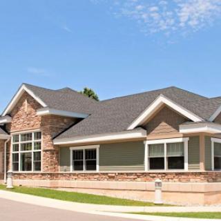 A contemporary residential house featuring a combination of brick and siding.