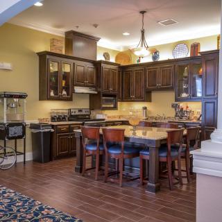 Spacious kitchen and dining area with wooden cabinets and modern appliances.