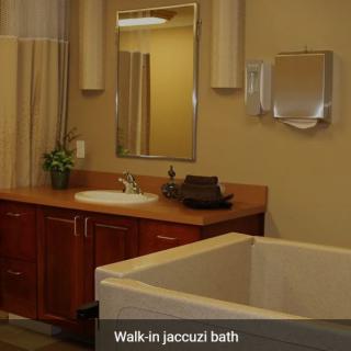 A modern bathroom featuring a walk-in jacuzzi bath.