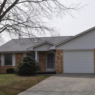 A suburban house with a brick facade and attached garage.