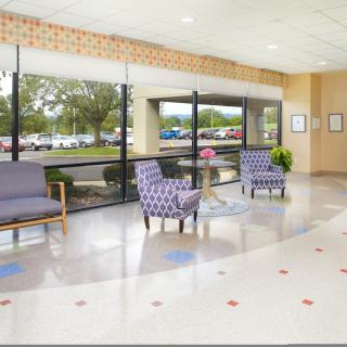 A bright and spacious lobby area with comfortable seating and large windows.