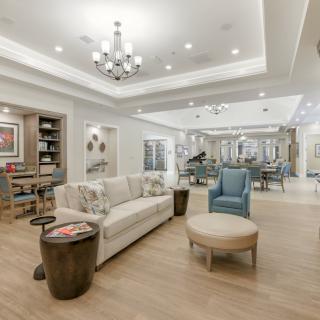 A spacious and elegantly designed living room featuring comfortable seating and modern decor.