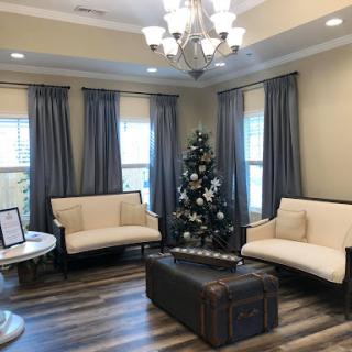 A cozy living room decorated for the holiday season, featuring a Christmas tree and elegant furnishings.