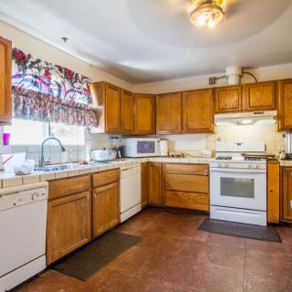 A well-lit kitchen with wooden cabinets and modern appliances.