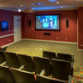 A cozy home theater setup with comfortable seating and a large screen.