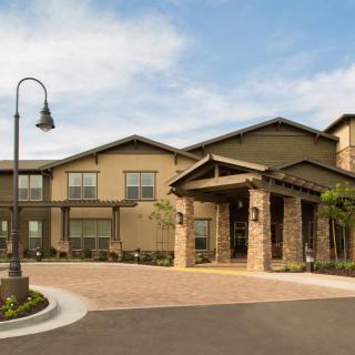 A modern residential building with a landscaped entrance.