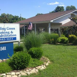 A nursing and rehabilitation center surrounded by well-maintained landscaping and an American flag.