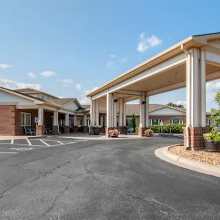 The welcoming entrance of a hotel, showcasing modern architectural style and a well-maintained landscape.