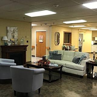 A cozy waiting room with comfortable seating and warm lighting.