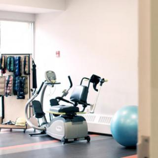 A small gym space featuring a stationary bike and exercise equipment.