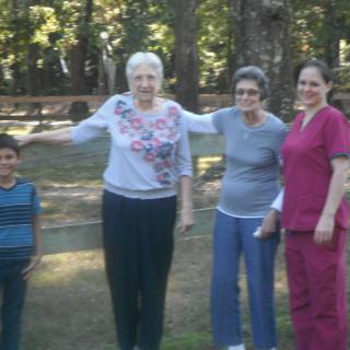 A group of people standing together outdoors in a park.