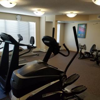 A gym with various fitness equipment including treadmills and an elliptical machine.
