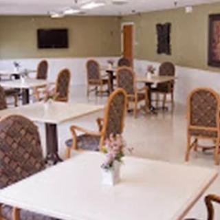 An empty dining area with neatly arranged tables and chairs.