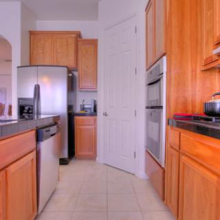 A modern kitchen with wooden cabinets and stainless steel appliances.