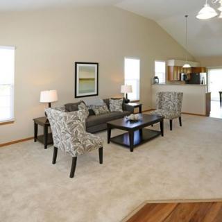 A spacious living room with a comfortable seating area and neutral color palette.