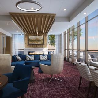 A modern lounge area with comfortable seating and large windows allowing natural light.