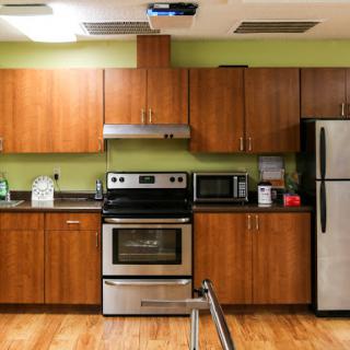 A modern kitchen featuring stainless steel appliances and wooden cabinets.