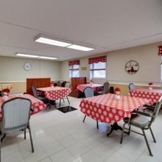A cozy dining room with checkered tablecloths and simple decor.