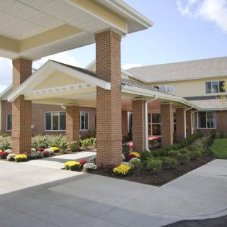 A well-maintained building with a covered entrance and landscaped surroundings.
