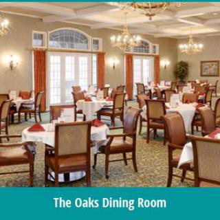 The Oaks Dining Room with elegantly set tables and chairs.