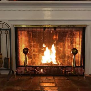 A warm, cozy fireplace burning brightly in a home interior.
