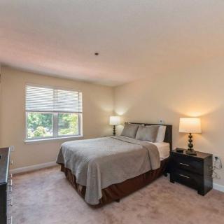 A cozy bedroom with a bed, nightstands, and soft lighting.