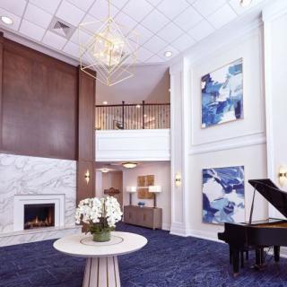 A luxurious lobby featuring a grand piano, chandelier, and modern artwork.