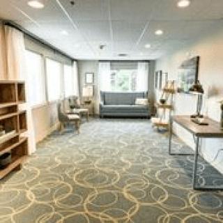 A modern office interior with sleek furniture and ample natural light.