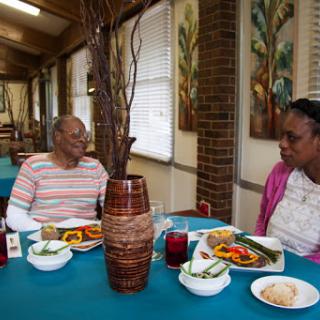 Two individuals enjoying a meal together in a cozy dining setting.