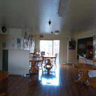 A cozy kitchen and dining area with wooden furniture and ample natural light.