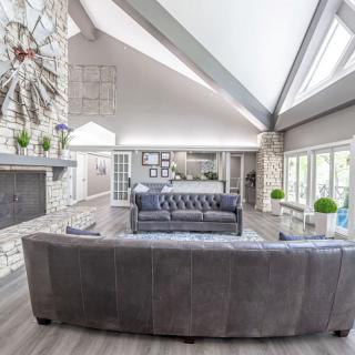 A spacious and modern living room with sleek furniture and large windows.